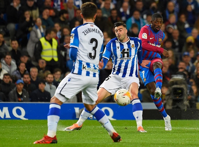 Barcelona's French midfielder Ousmane Dembele (R) vies with Real Sociedad's Spanish defender Diego Rico during the Spanish League football match between Real Sociedad and FC Barcelona at the Anoeta stadium in San Sebastian on April 21, 2022. PHOTO | AFP
