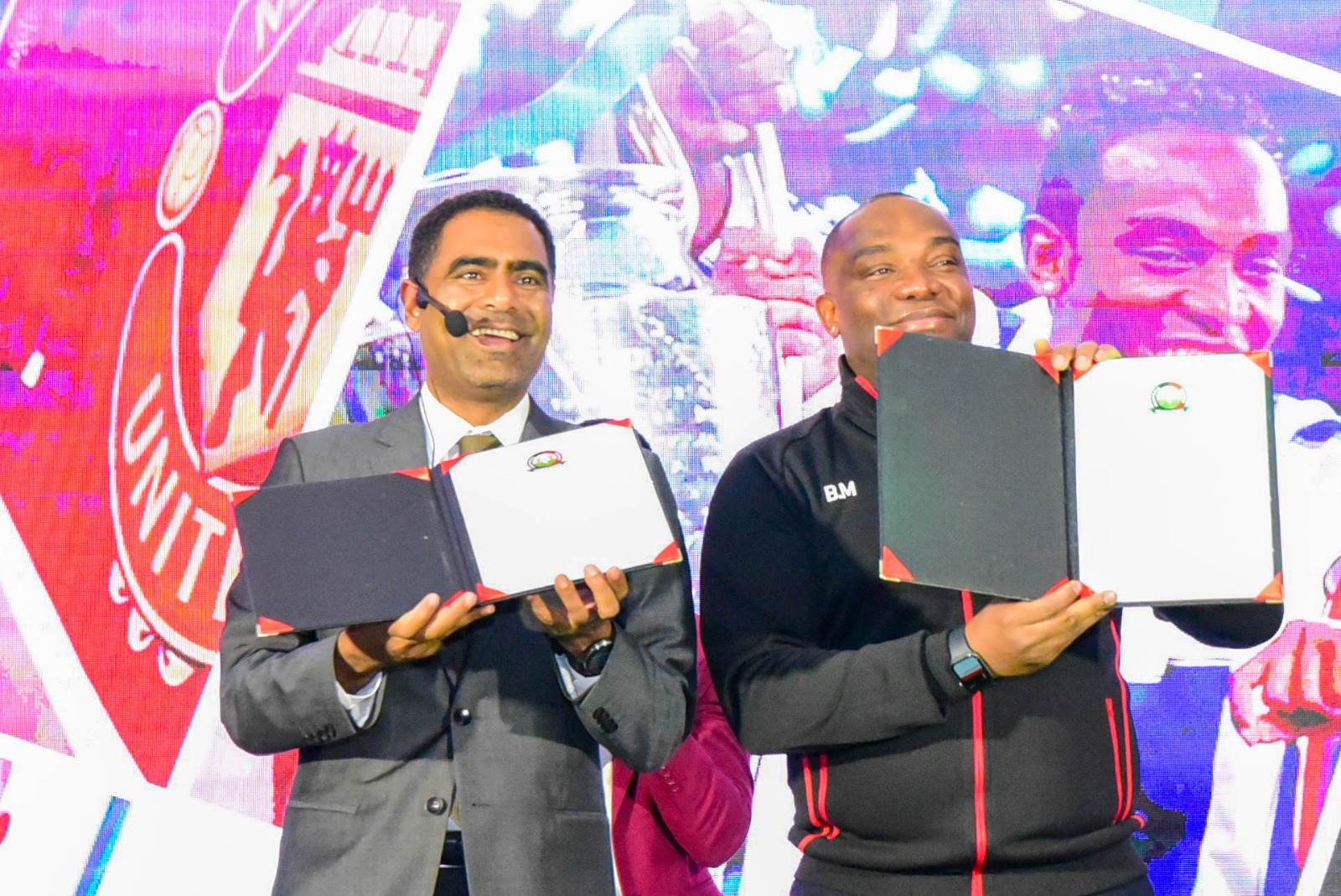 New Harambee Stars coach Benni McCarthy displays his contract alongside FKF president Hussein Mohammed during his unveiling in Nairobi on March 3, 2025. (Photo. FKF Media).