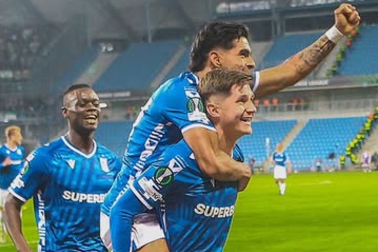 Timothy Ouma celebrates with teammates in big win