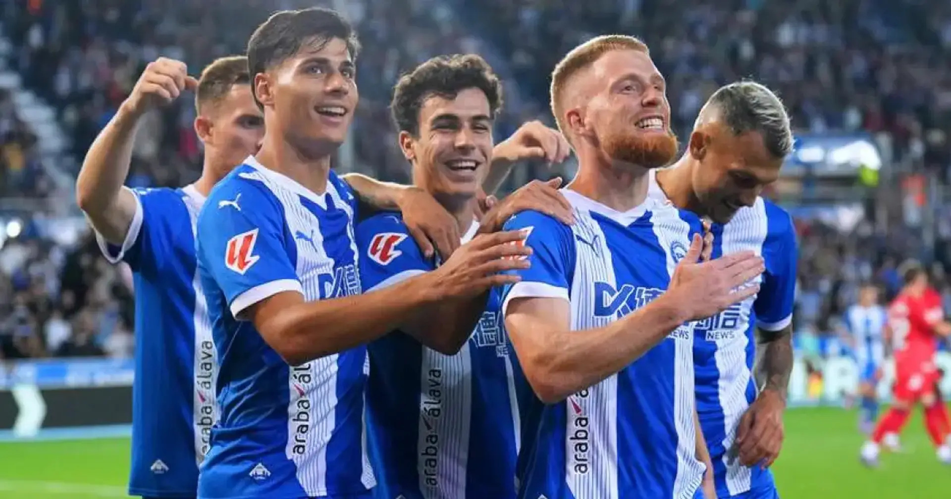 Alavés squad members celebrate a key match moment on the field.